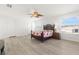 Bright bedroom with wood-look floors and ceiling fan at 8919 N River Rd, Tampa, FL 33635