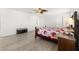 Large bedroom with wood-look floors and ceiling fan at 8919 N River Rd, Tampa, FL 33635