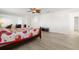 Spacious bedroom with wood-look floors and ceiling fan at 8919 N River Rd, Tampa, FL 33635