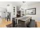 Modern dining room with a pool table, chandelier, and hardwood floors at 8919 N River Rd, Tampa, FL 33635