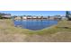 Serene pond view with surrounding houses at 8919 N River Rd, Tampa, FL 33635