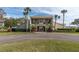 Community clubhouse with palm trees and landscaping at 90 S Highland Ave # 12, Tarpon Springs, FL 34689