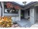 Inviting front porch with hanging flower baskets at 90 S Highland Ave # 12, Tarpon Springs, FL 34689