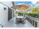 Relaxing patio with table and chairs, shaded by an umbrella at 90 S Highland Ave # 12, Tarpon Springs, FL 34689