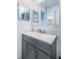 Modern bathroom with gray vanity and a mirrored medicine cabinet at 9209 Seminole Blvd # 138, Seminole, FL 33772