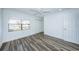 Bright bedroom with wood-look floors and water view at 9209 Seminole Blvd # 138, Seminole, FL 33772