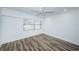 Bright bedroom with wood-look floors and ceiling fan at 9209 Seminole Blvd # 138, Seminole, FL 33772