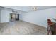 Living area with wood-look floors and kitchen access at 9209 Seminole Blvd # 138, Seminole, FL 33772