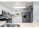 Kitchen with stainless steel appliances and view at 10061 Lake Oak Cir, Tampa, FL 33624