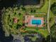 Arial view of community pool, landscaping, and lake at 10330 Carrollwood Ln # 93, Tampa, FL 33618