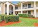 Neatly landscaped condo building with a walkway and manicured hedges at 10330 Carrollwood Ln # 93, Tampa, FL 33618