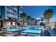 Luxury pool area with lounge chairs, palm trees, and city views at 1101 E Jackson St # 1808, Tampa, FL 33602