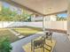 Covered patio with seating area overlooking a grassy backyard at 1103 S Prospect Ave, Clearwater, FL 33756