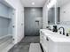 Modern bathroom with gray tile shower and double vanity at 1103 S Prospect Ave, Clearwater, FL 33756