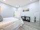 Main bedroom with white bedding, gray accents, and full-length mirror at 1103 S Prospect Ave, Clearwater, FL 33756