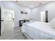Main bedroom with white bedding and a view of the kitchen at 1103 S Prospect Ave, Clearwater, FL 33756