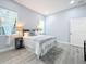 Bright bedroom with gray bedding and en-suite bathroom at 1103 S Prospect Ave, Clearwater, FL 33756