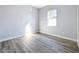 Bright bedroom with gray wood-look floors and a window at 1103 S Prospect Ave, Clearwater, FL 33756