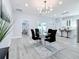 Open concept dining area with modern glass table and chandelier at 1103 S Prospect Ave, Clearwater, FL 33756