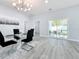 Elegant dining room with glass table and access to backyard patio at 1103 S Prospect Ave, Clearwater, FL 33756