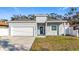 Newly built gray house with white garage door at 1103 S Prospect Ave, Clearwater, FL 33756