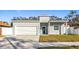 Gray house with white garage door and landscaping at 1103 S Prospect Ave, Clearwater, FL 33756