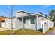 Side view of gray house, white fence, and tree at 1103 S Prospect Ave, Clearwater, FL 33756