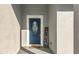 Navy blue front door with a welcome mat at 1103 S Prospect Ave, Clearwater, FL 33756