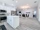 Modern kitchen with white cabinets, stainless steel appliances and island at 1103 S Prospect Ave, Clearwater, FL 33756