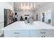 Large kitchen island with white quartz countertop and modern pendant lighting at 1103 S Prospect Ave, Clearwater, FL 33756