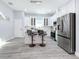 Bright white kitchen with center island and stainless steel appliances at 1103 S Prospect Ave, Clearwater, FL 33756