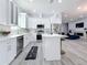 Open concept kitchen with white cabinets and large island at 1103 S Prospect Ave, Clearwater, FL 33756
