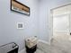 Bright laundry room with two hampers and access to another room at 1103 S Prospect Ave, Clearwater, FL 33756