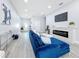 Open concept living room featuring a blue sofa and electric fireplace at 1103 S Prospect Ave, Clearwater, FL 33756