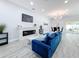 Open living area with blue sofa and modern fireplace at 1103 S Prospect Ave, Clearwater, FL 33756