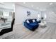Bright living room with blue sectional sofa and modern fireplace at 1103 S Prospect Ave, Clearwater, FL 33756