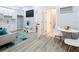 Open concept living room with kitchenette, dining area, and bathroom access at 1103 S Prospect Ave, Clearwater, FL 33756