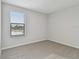 Simple bedroom with gray carpeting and window at 11127 Hudson Hills Ln, Riverview, FL 33579