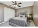 Cozy bedroom with a ceiling fan and double door closet, featuring a gray bed frame and bedding at 11127 Hudson Hills Ln, Riverview, FL 33579