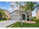 Two-story house with gray siding, two-car garage, and landscaping at 11127 Hudson Hills Ln, Riverview, FL 33579