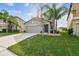 Two-story house with gray siding, two-car garage, and manicured lawn at 11127 Hudson Hills Ln, Riverview, FL 33579