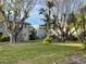 Landscaped community backyard with mature trees at 1151 Rue Des Chateaux, St Petersburg, FL 33707