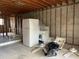 Unfinished basement with appliances and flooring at 1151 Rue Des Chateaux, St Petersburg, FL 33707