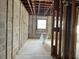 Unfinished bedroom with exposed framing and a window at 1151 Rue Des Chateaux, St Petersburg, FL 33707