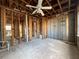 Unfinished bedroom with exposed framing and ceiling fan at 1151 Rue Des Chateaux, St Petersburg, FL 33707