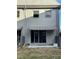 Back exterior view showing a patio with a striped awning at 1151 Rue Des Chateaux, St Petersburg, FL 33707