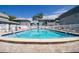 Relaxing community pool with surrounding patio at 1151 Rue Des Chateaux, St Petersburg, FL 33707