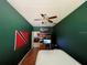 Green-walled bedroom with a queen-size bed and TV at 1218 Vinetree Dr, Brandon, FL 33510
