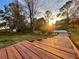 Wooden dock extending over calm water at sunset at 1218 Vinetree Dr, Brandon, FL 33510