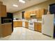 Galley kitchen with wood cabinets and modern appliances at 1218 Vinetree Dr, Brandon, FL 33510